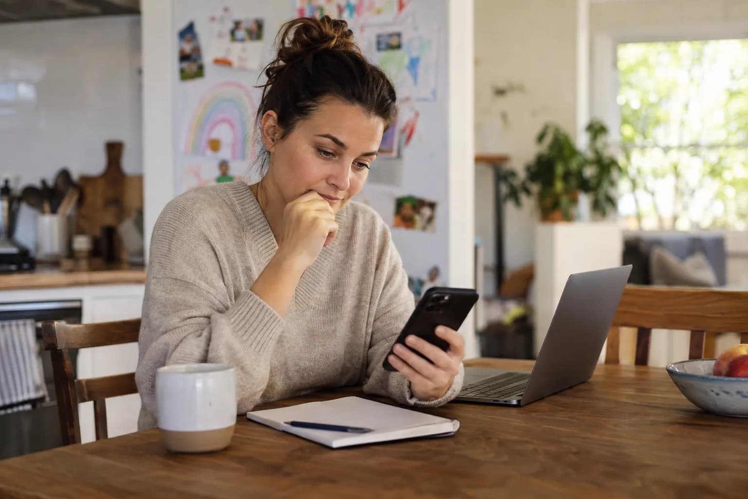 Parent comparing rewards apps on a phone, deciding which one to download for their kids